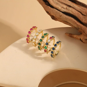 Detailed macro view of minimalist gold plated rings with colorful zircon gemstones