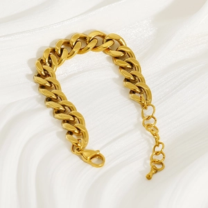 Thick 18k gold plated stainless steel Cuban link bracelet on white silk background