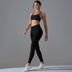 Detail of seamless black yoga set with high-waist leggings and V-back sports bra