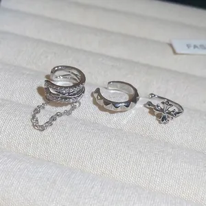 Three-piece silver ear cuff set with pavé zircon heart, chain, and retro cross designs