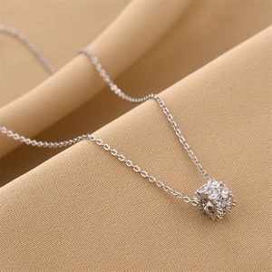 Elegant silver titanium steel necklace featuring a barrel pendant set with sparkling zircons