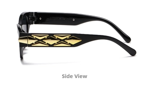 Detail view of black cat eye sunglasses featuring a golden geometric X-shaped temple relief