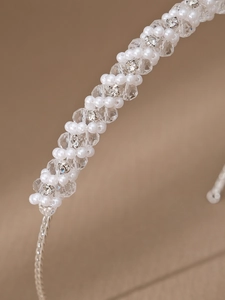Macro detail of exquisite handmade crystal beads and white imitation pearls on a headband