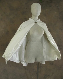 Short white satin Christmas cape with velvet trim and decorative neckline crystal button