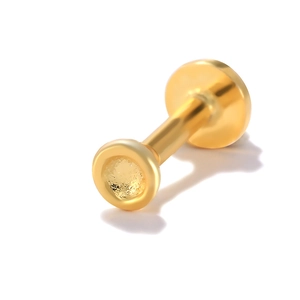 Detailed macro view of a golden S925 sterling silver flat back stud earring with stud shaft