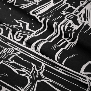 Macro detail of gothic black and white tapestry fabric with skeletal hand print