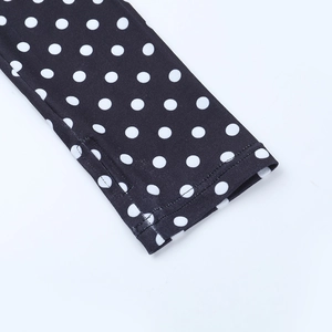 Detailed macro view of black polka dot pattern and knitted fabric texture with clean stitching