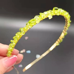 Detail of handmade crown headband with yellow crystal stones and golden wire wrapping