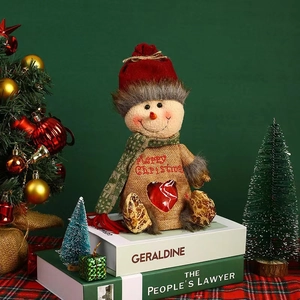 Detailed view of burlap Christmas snowman gift bag with Merry Christmas embroidery and heart window