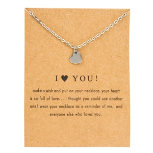 Close-up of silver heart pendant necklace on brown kraft card with I Love You message