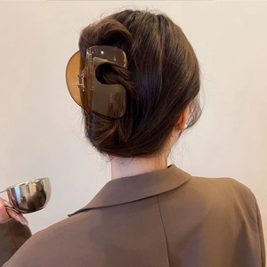 Brown transparent large hair claw clip styled on model in vintage aesthetic