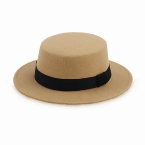 Detail shot of a camel felt pork pie hat with a black ribbon band on a white background