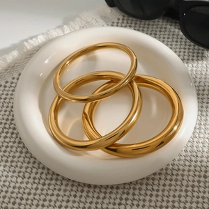 Three-piece set of 18k gold-plated stainless steel bangles with a high-polished finish