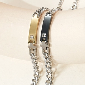 Detailed shot of gold and black stainless steel cross bracelets with zircon stones