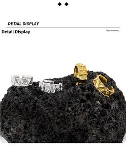 Detail view of S925 sterling silver rings with irregular lava texture on volcanic rock