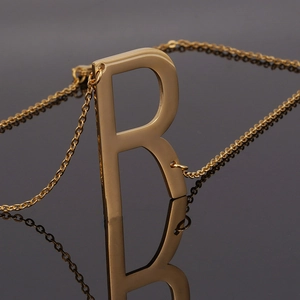 18K gold plated stainless steel necklace featuring a polished letter R pendant with reflection