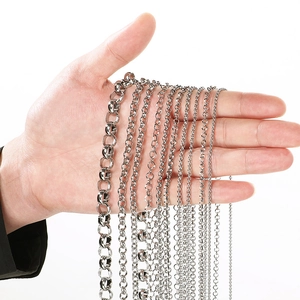 Close-up of hand holding multiple 304 stainless steel bead and oval link jewelry chains