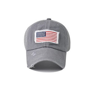 Detailed close-up of distressed cotton mesh back cap with embroidered American flag patch
