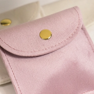 Pink and beige velvet jewelry pouches with gold metal snap buttons for ring storage