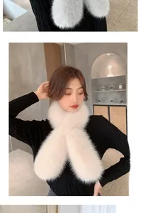 Close-up of fluffy faux fox fur scarf in cream white with soft crossed texture