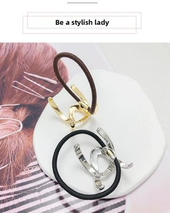 Detail of minimalist gold and silver U-shaped metal hair ties with stylish hair ties