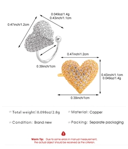 Macro view showing dimensions and weight of micro-pave heart ear cuffs in copper