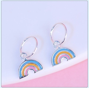 Macro shot of s925 silver rainbow charms with blue, yellow and pink enamel details