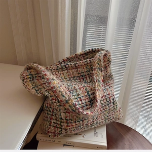 Detail of colorful tweed knit tote bag showing vibrant texture and woven yarn patterns