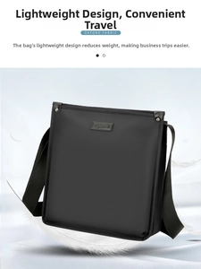 Close-up of a black oxford fabric crossbody bag featuring a metal logo and hardware