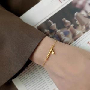 18k gold plated bamboo link bracelet with leaf pendant shown on wrist for women
