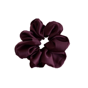 Elegant deep purple scrunchie made of textured silk-like fabric with a pleated design