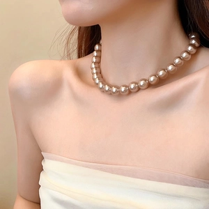 Elegant champagne pearl necklace on model, luxury fashion clavicle chain jewelry piece