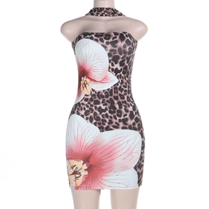 Detail of leopard print mini dress featuring large pink orchid floral pattern and neck strap