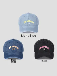 Three colors of washed denim baseball caps with Los Angeles embroidery in soft lighting