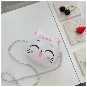 Flat lay of cute white cat-shaped PU leather crossbody bag for girls with fruit decor