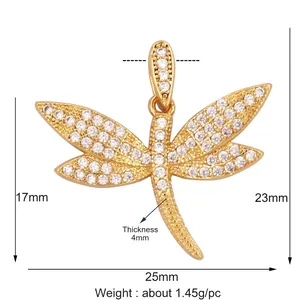 Macro shot of gold dragonfly pendant with white zircon micro-pave detailing and dimensions