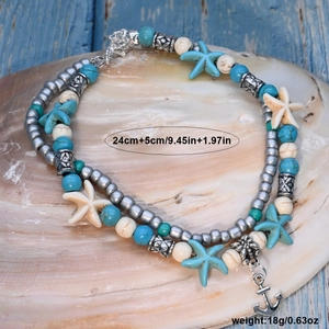 Double-layer ocean anklet with turquoise starfish and anchor charm on a shell
