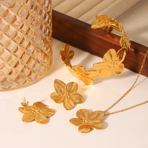 18K gold plated stainless steel jewelry set featuring textured five-petal flower motifs