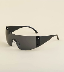Close-up of black Y2K wraparound sunglasses with decorative silver star on the temple