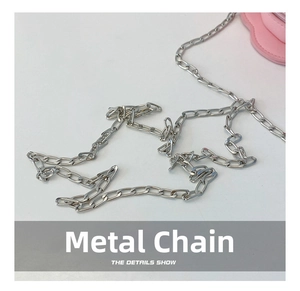 Detail of durable silver alloy chain strap on a pink floral round shoulder bag for kids