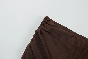Detailed view of dark brown mesh fabric texture with elegant vertical ruching details