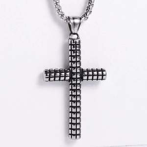 Detail of silver stainless steel cross pendant featuring unique grid texture on bead chain