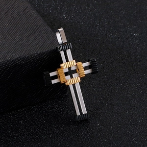Macro shot of punk cross pendant featuring gold and black gear textures on silver metal