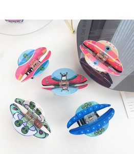Colorful UFO acrylic hair clips set with cartoon alien motifs on a white surface