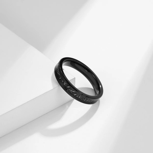 Minimalist black tungsten ring with brushed texture on white geometric background