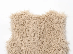 Detailed close-up showing the soft beige faux fur texture and neckline of the vest