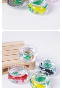 Detailed close-up of miniature koi fish bowl models with green water plants and colorful fish