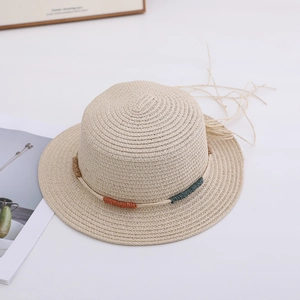 Detail of a beige boater straw hat with colorful woven rope trim on white background