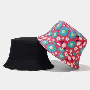Dual-style reversible bucket hats featuring plain black and vibrant red floral cotton canvas