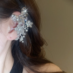 Detail of silver butterfly zircon tassel ear cuff with sparkling rhinestones on model